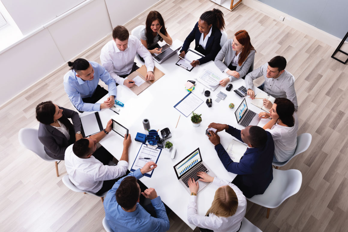 Group of employees sitting around a table