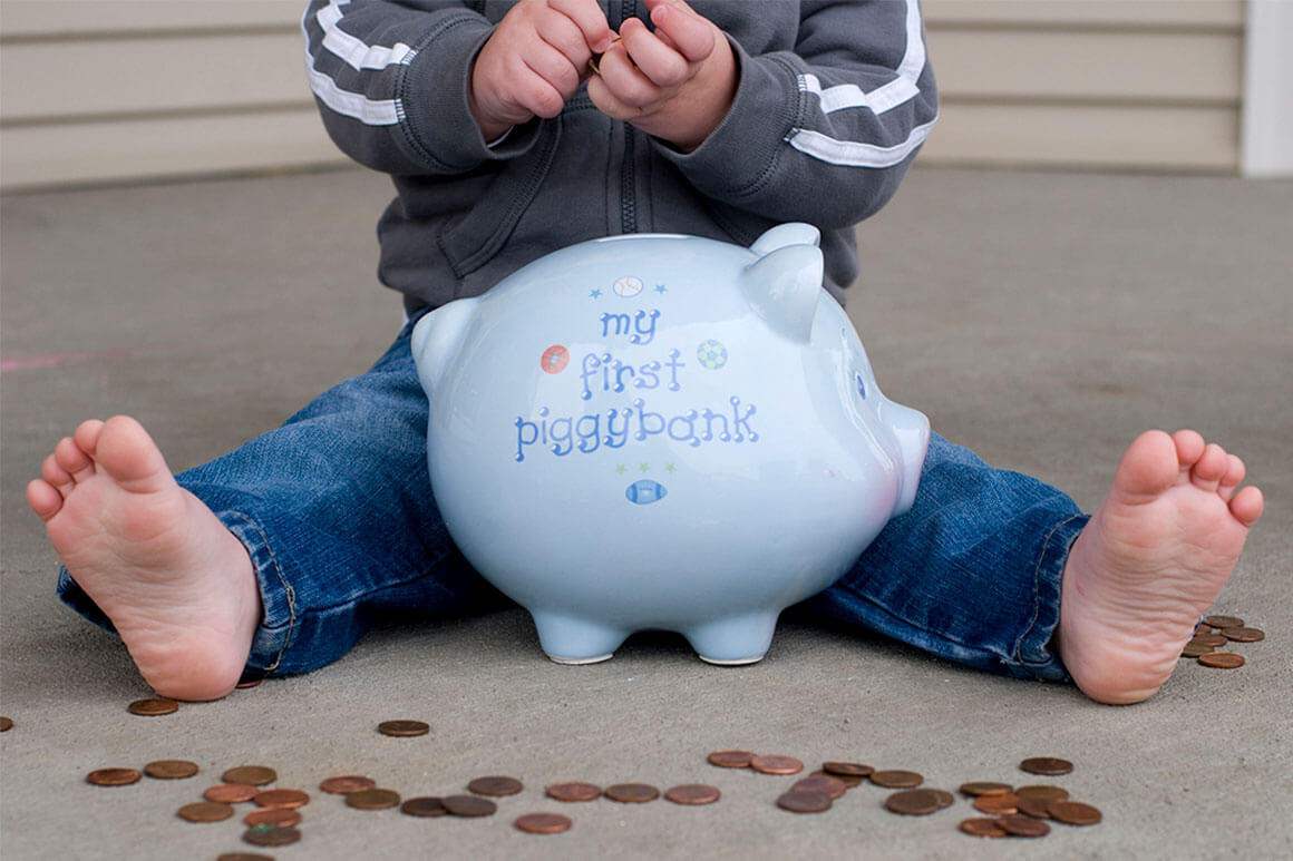 Baby with piggy bank and coins