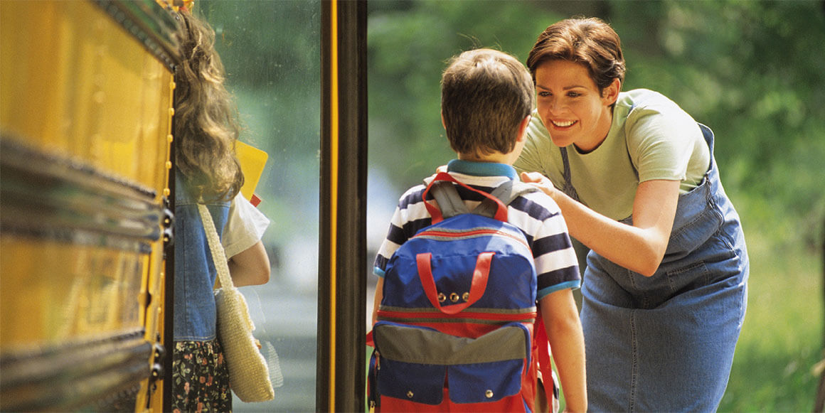 Mom dropping son off at school bus