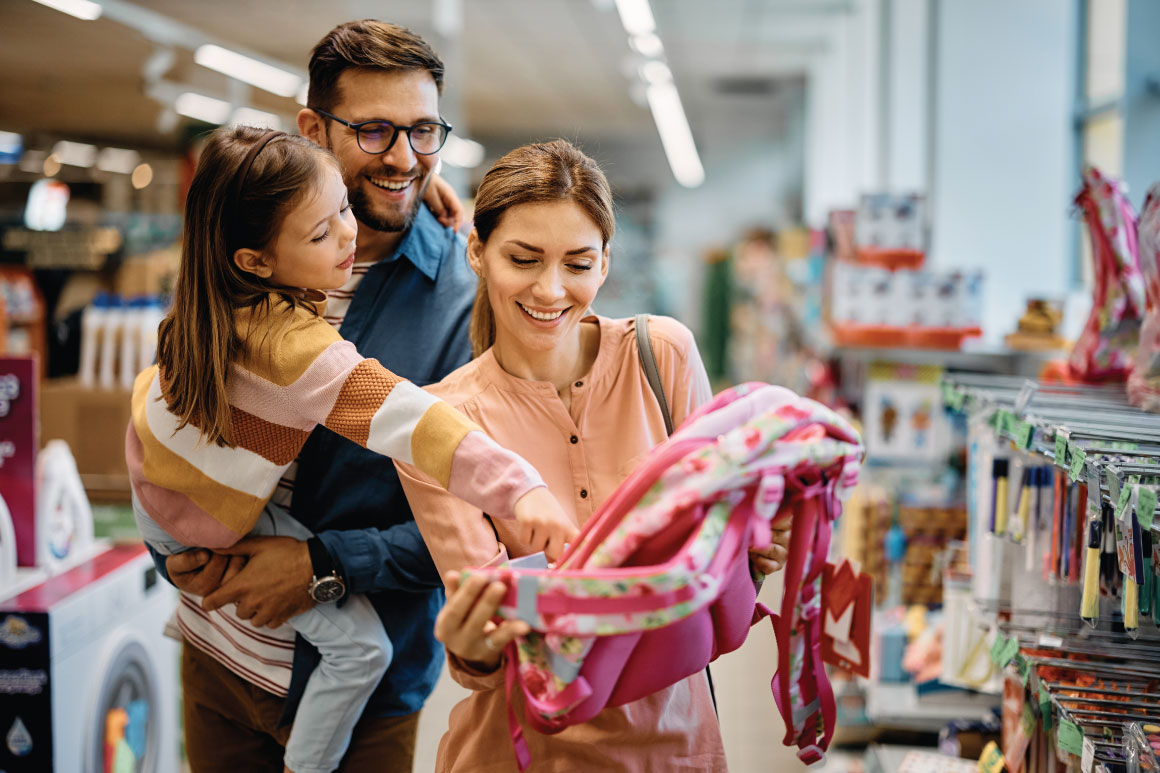Parents with daughter picking out clothes