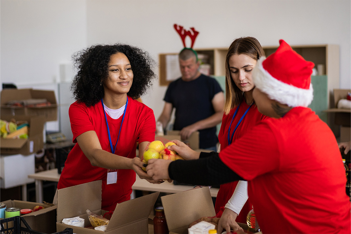Woman giving another woman a bag of lemons