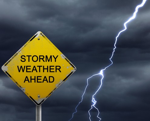 Stormy Weather Ahead sign with lightning in the sky