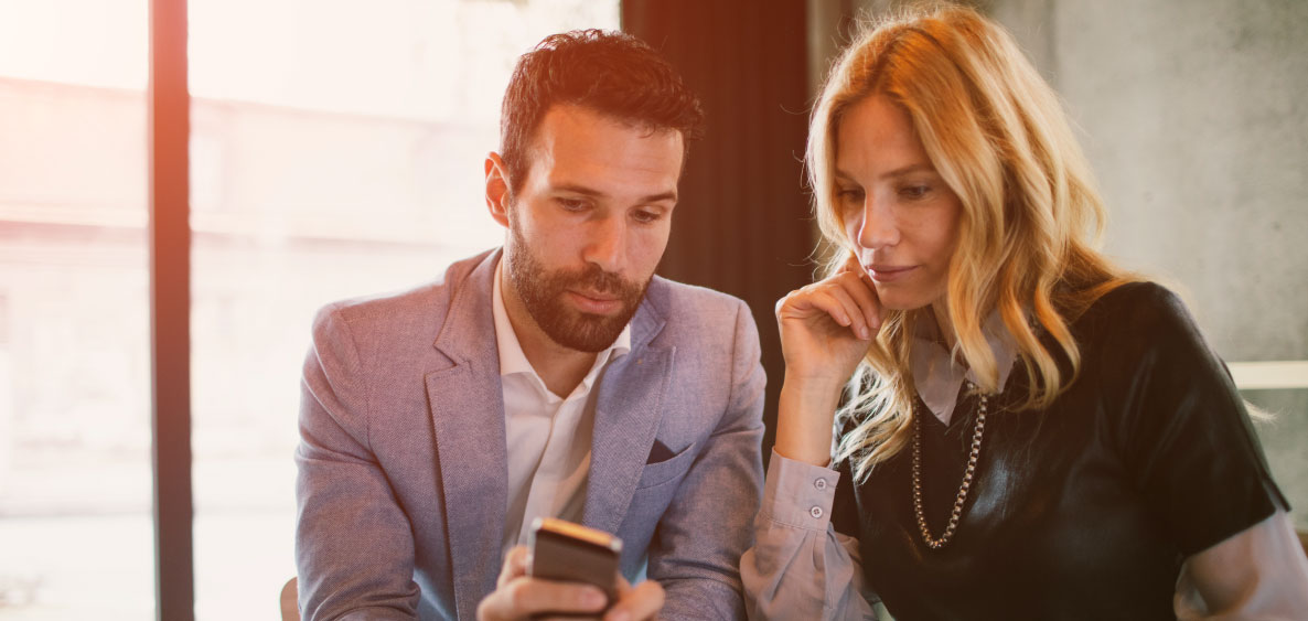 Man and woman looking at smartphone
