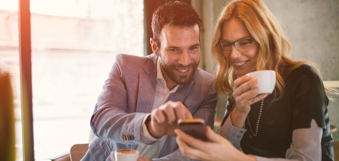 Man and woman looking at smartphone