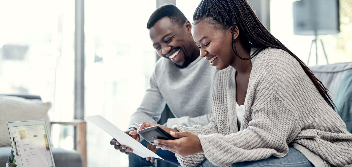 Happy couple reviewing their finances together