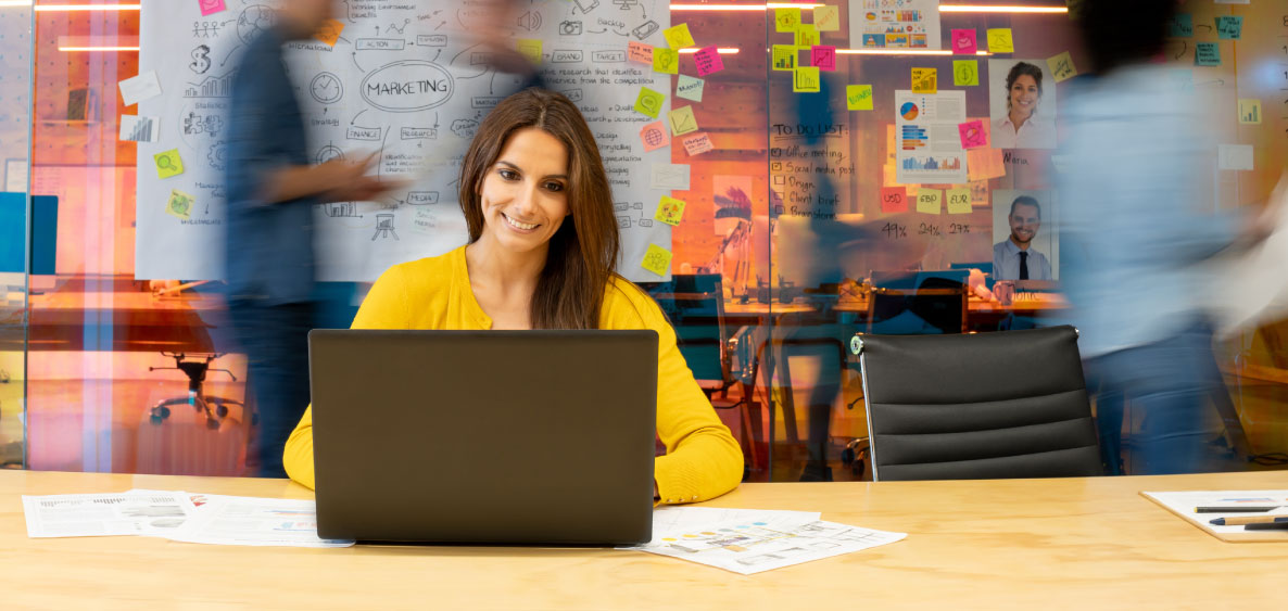 Lady in yellow in front of a laptop