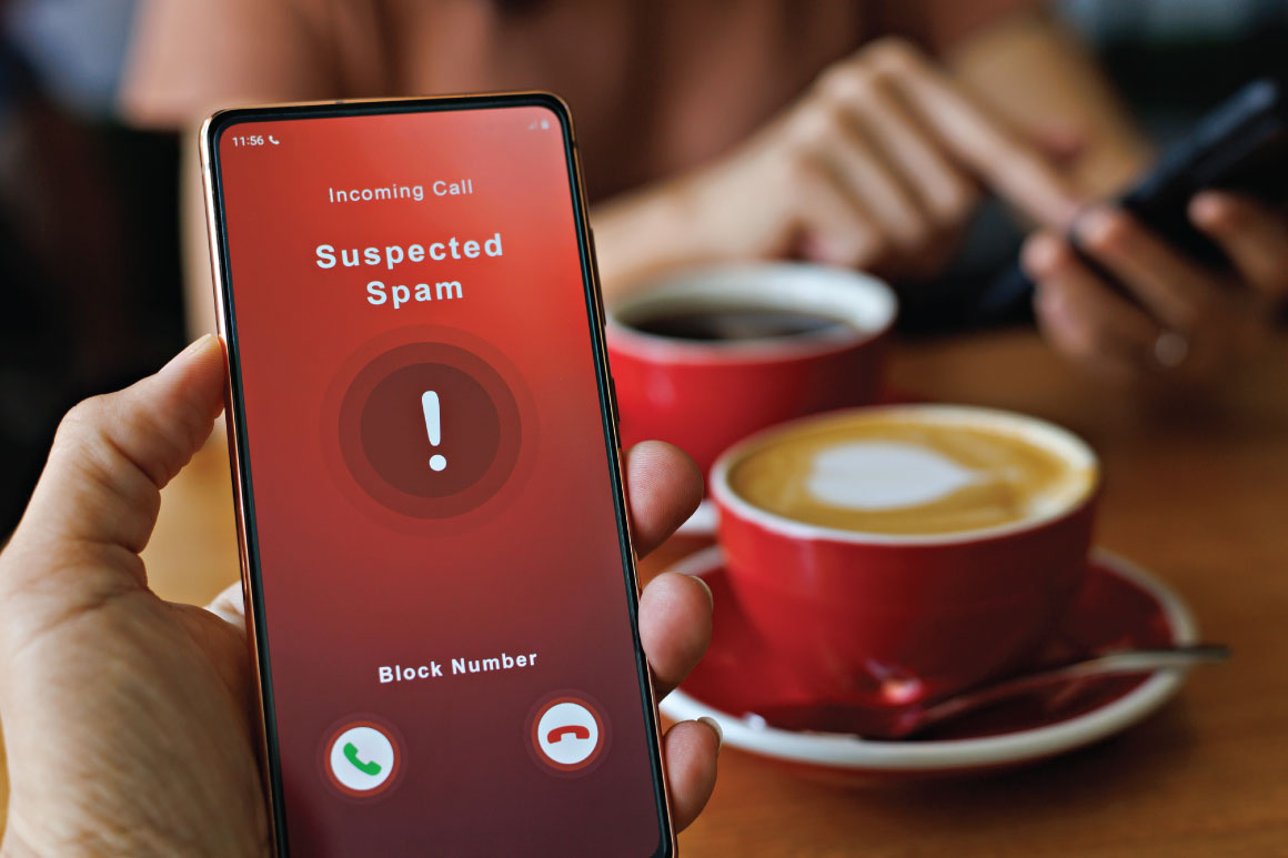 Suspected Spam call on a cell phone over coffee