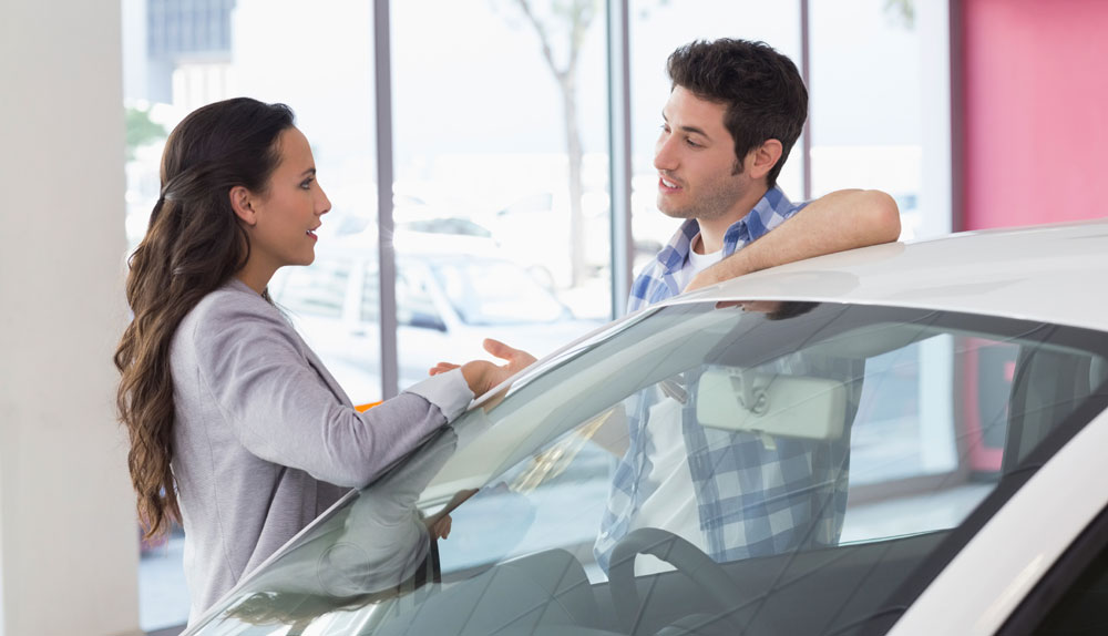 Man and woman at car dealership