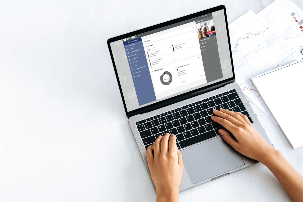 Hands typing on laptop with First United Bank Online Banking portal on the screen