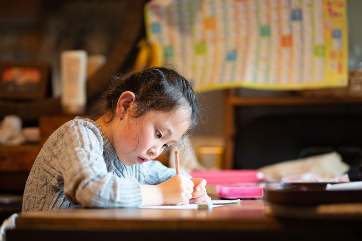 Little girl studying on a desk