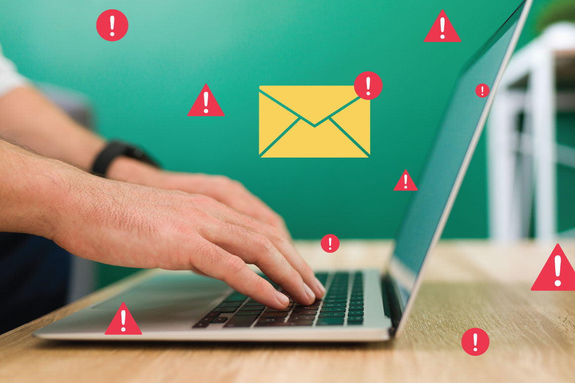 Hand on laptop emailing