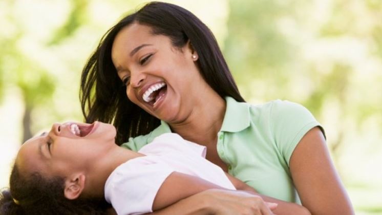 Mom laughing with daughter
