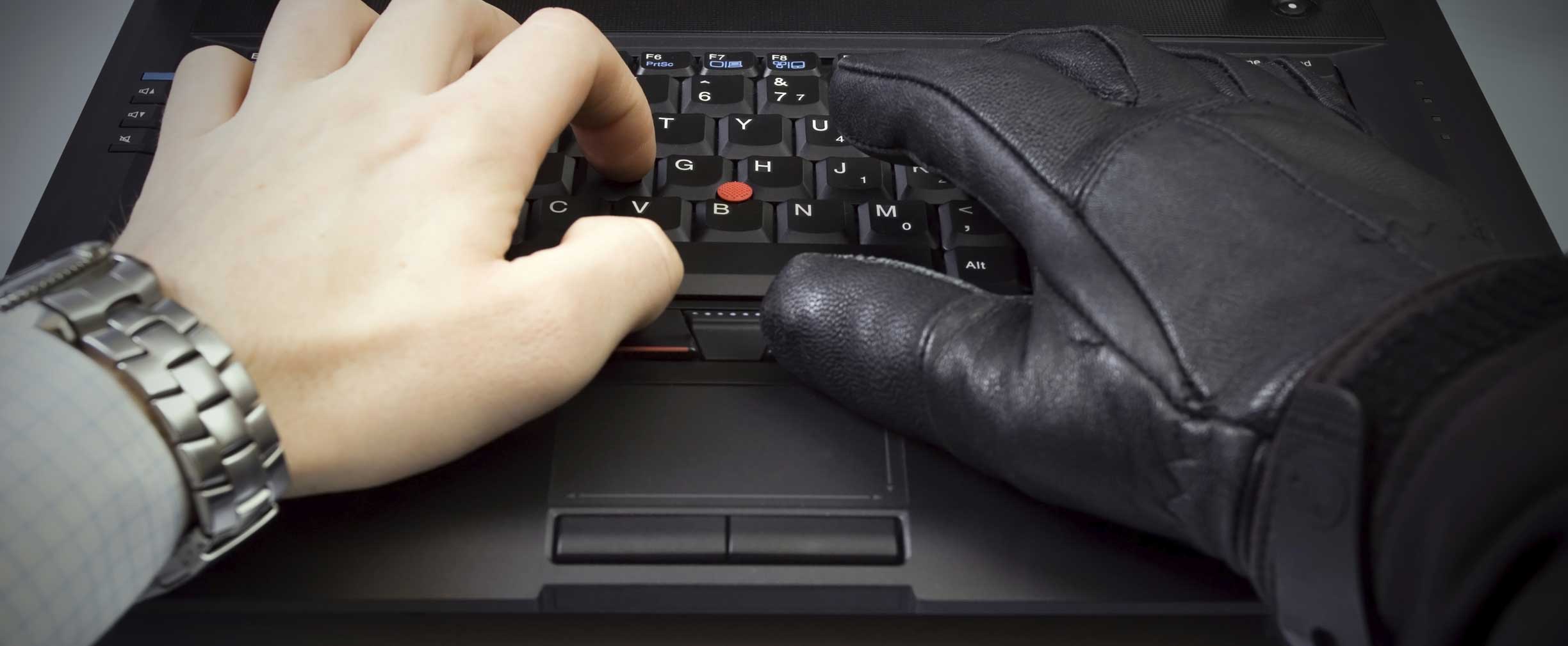 Hands typing on a laptop keyboard