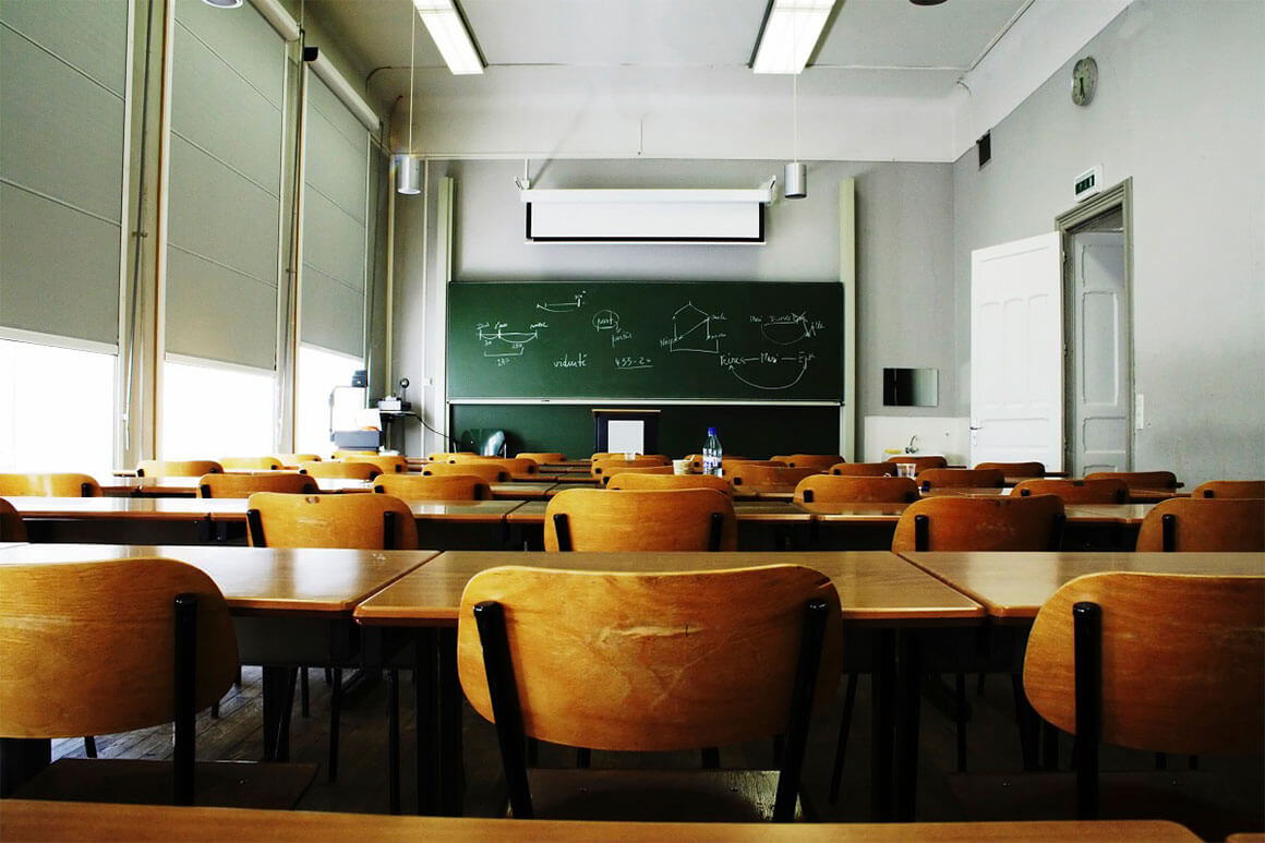 Empty chairs in an empty classroom