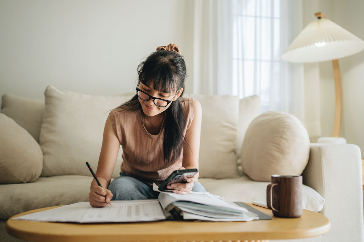 Woman writing in her financial notebook