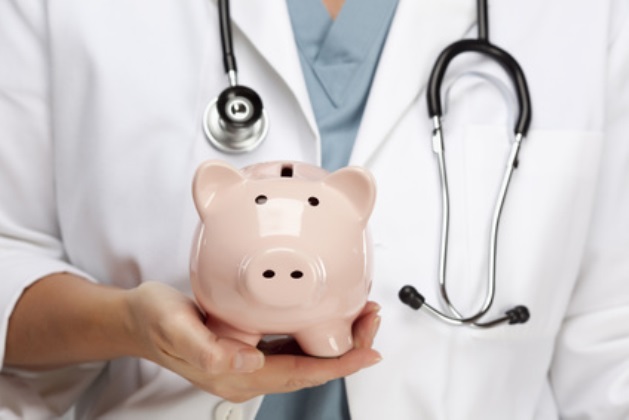 Doctor holding a piggy bank