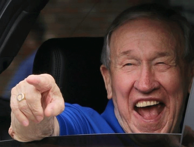 John Massey smiling in a car