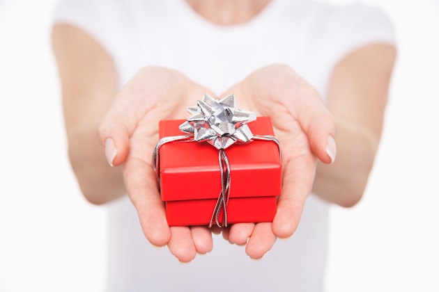 Hand holding red present