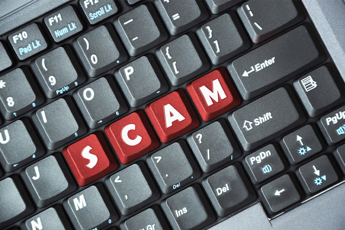 Computer keyboard with the letter scams in red