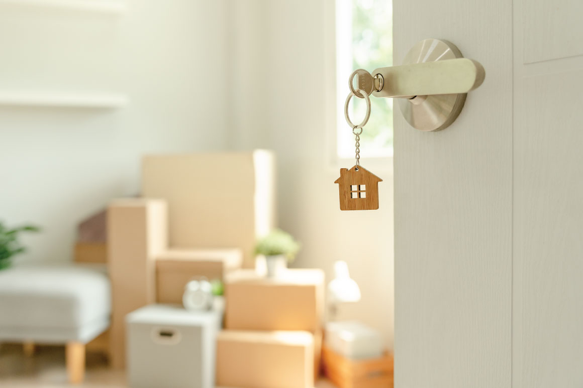 Home with door open with a house keychain