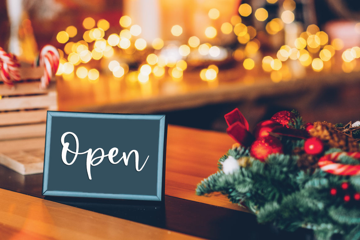 Open sign next to Christmas decorations