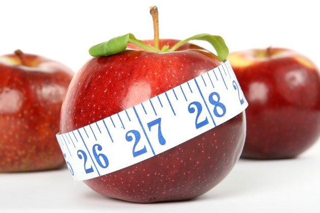 Apple with measuring tape wrapped around it 
