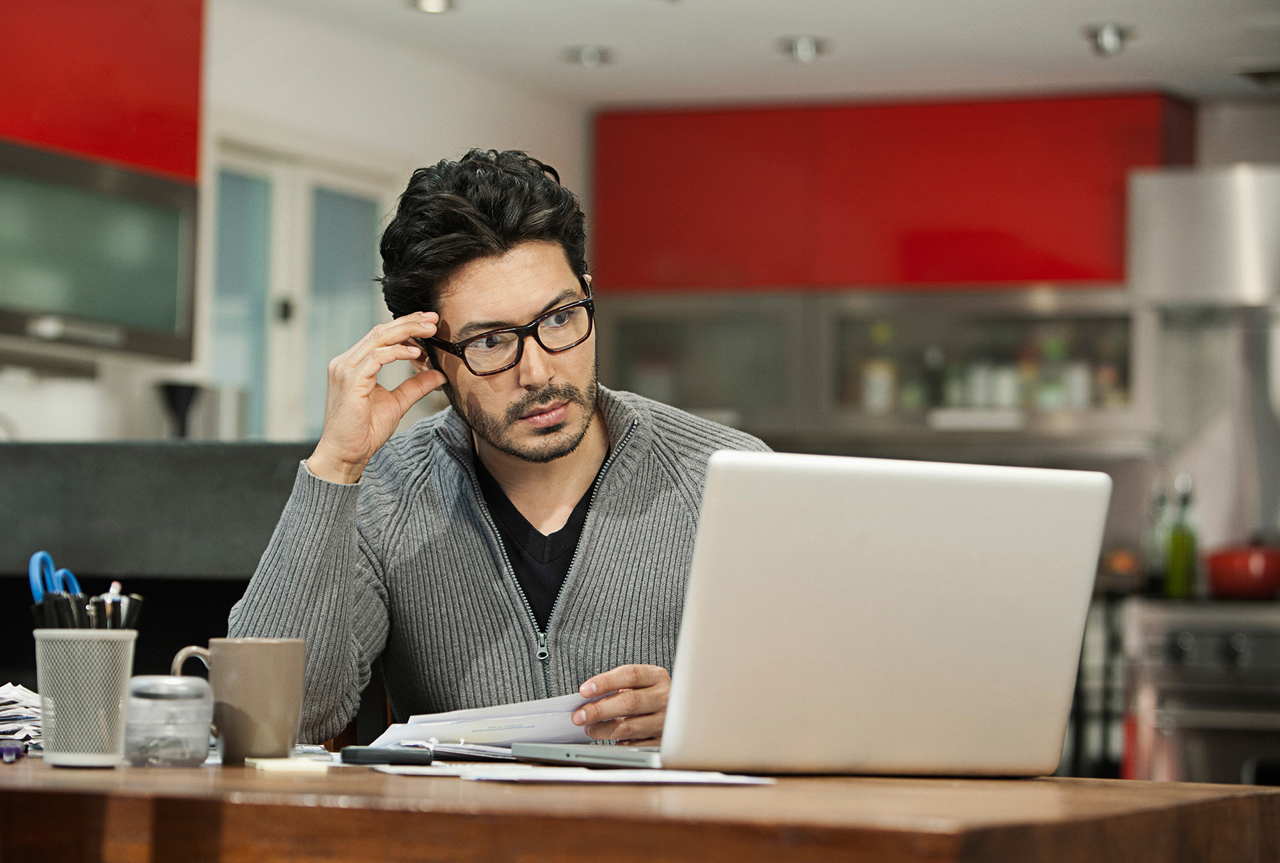 Man with classes on his laptop