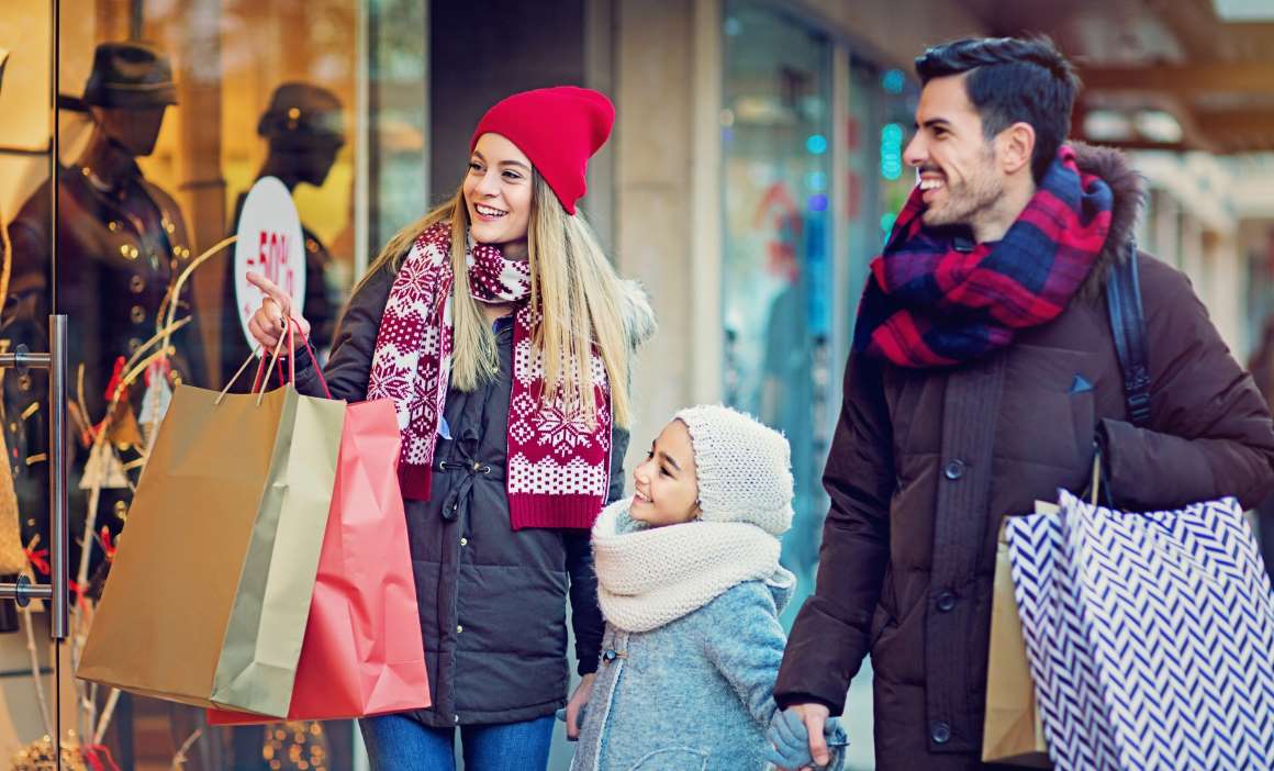 Couple with their daughter holiday shopping
