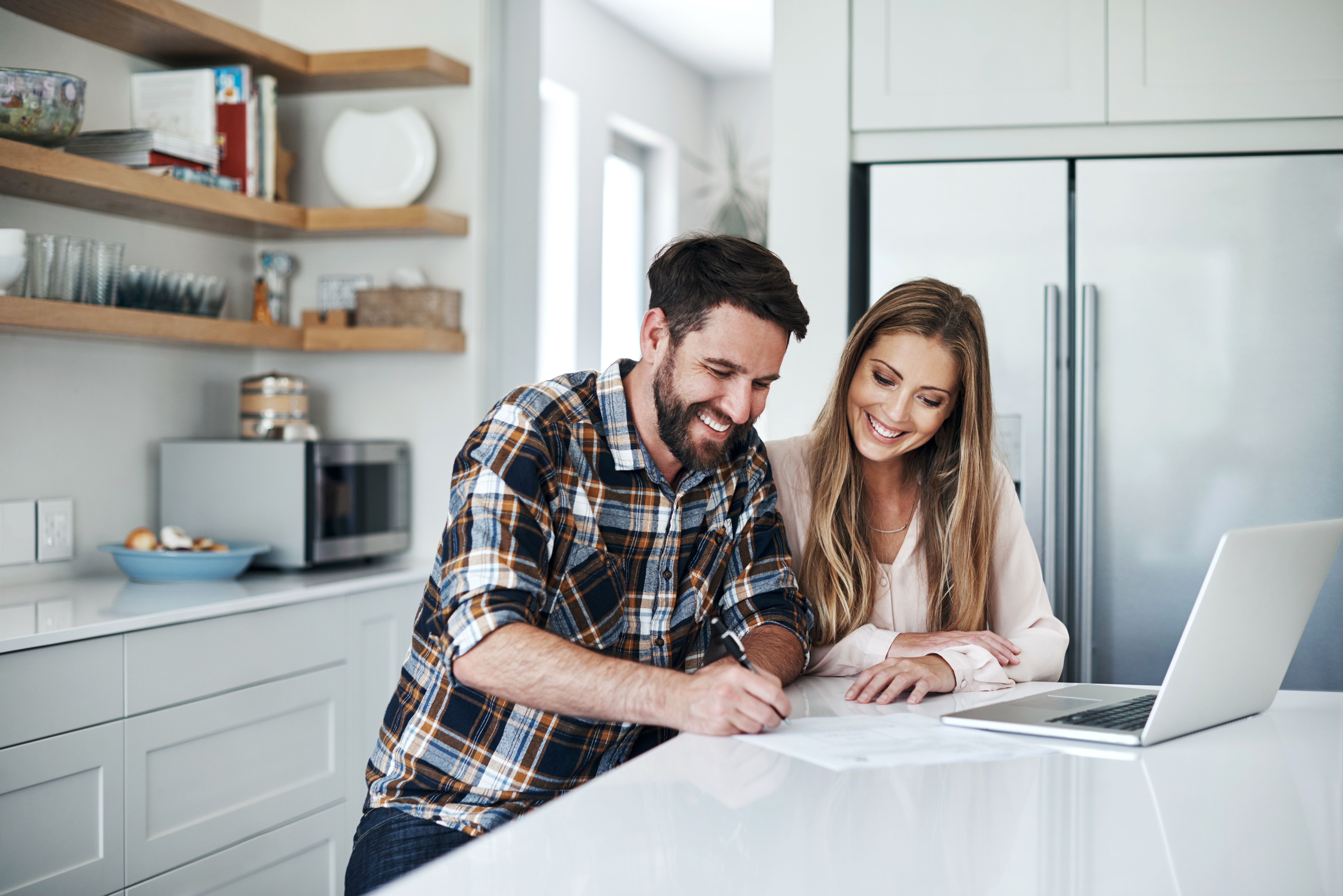 Couples in the kitchen working on their tax refund