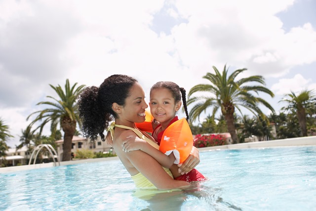 Woman and daughter in a swimming pool