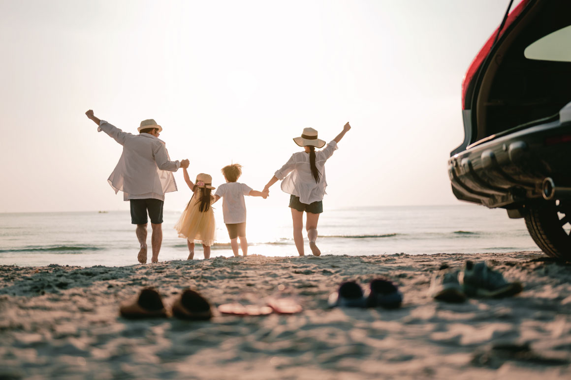 family on summer vacation together on the beach