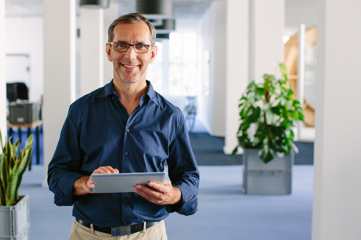 Man on ipad smiling