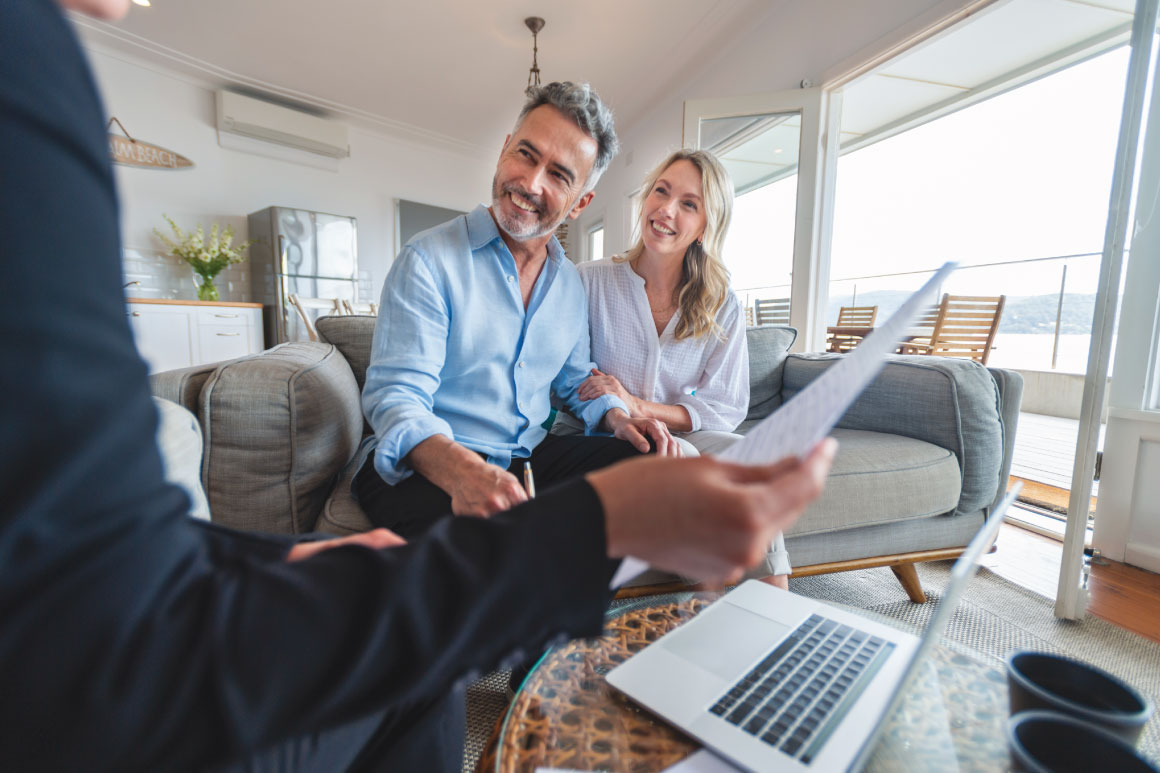 Husband and wife meeting with their tax advisor in the living room