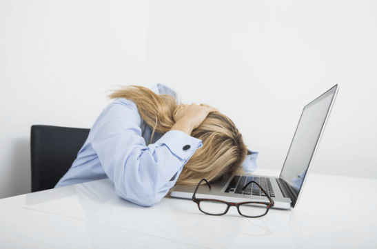 Woman putting on head on the desk