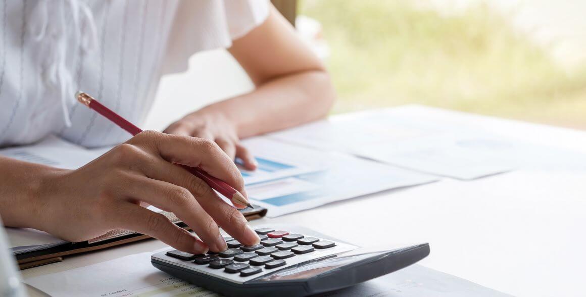 Hand on calculator
