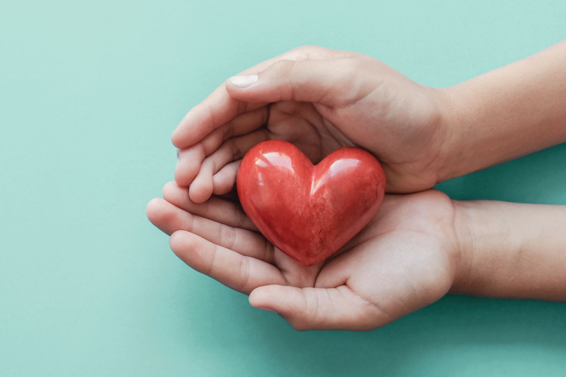Hand holding a red heart