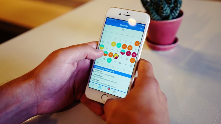 Hand holding phone with calendar