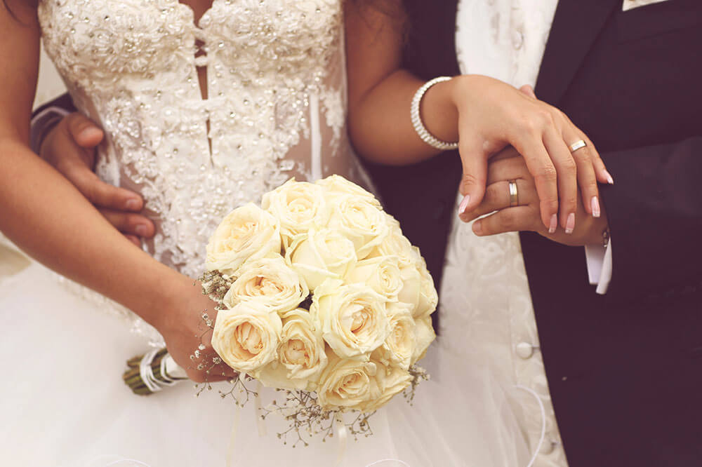 Bride and groom holding hands